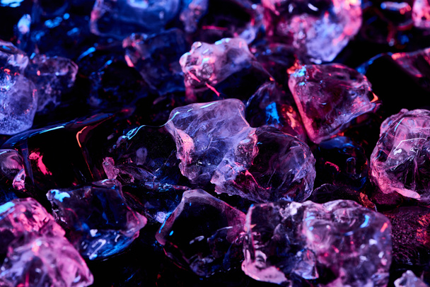 transparent ice cubes with purple illumination isolated on black - Fotoğraf, Görsel