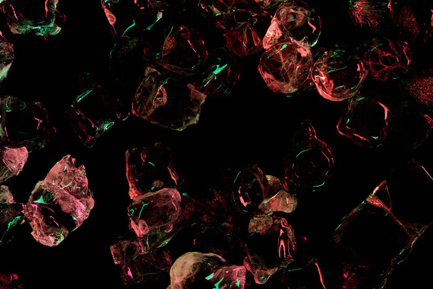top view of ice cubes with red and green illumination isolated on black - Photo, Image