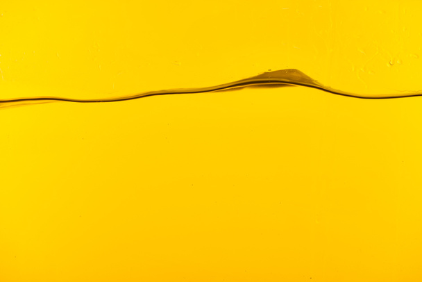 transparent deep water on yellow background - Foto, Imagem