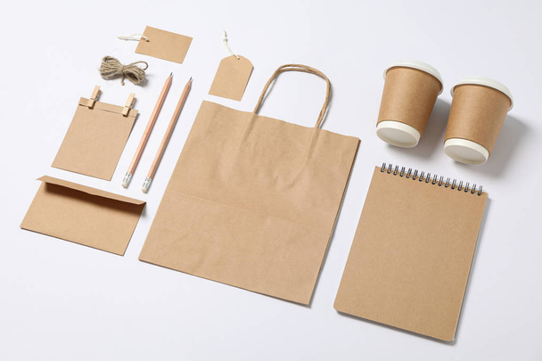 Composition with blank stationery, paper cups and bag on white b - Photo, Image