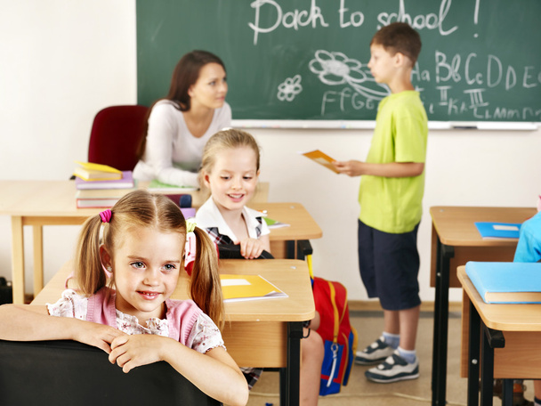 Children in classroom near blackboard. - Фото, зображення