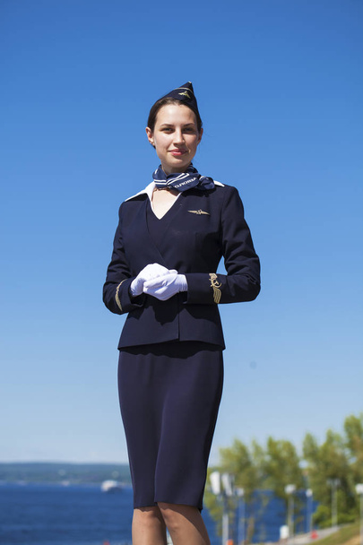 Beautiful stewardess dressed in official blue uniform  - Photo, Image