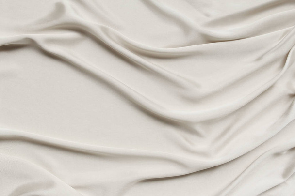 ecru, cream beautiful satin draped with soft folds, silk cloth background, close-up, copy space - Fotoğraf, Görsel