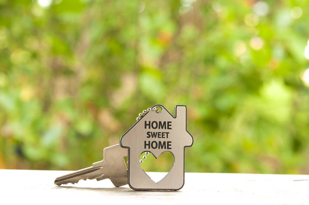  House key on a house shaped keychain. Real estate concept - Photo, Image