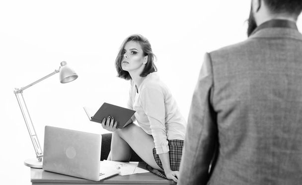 Providing business courses. Man in formal wear looking at sexy teacher sitting on desk in business school. Sexi coach coaching businessman to grow his business. Passion for business - Photo, image