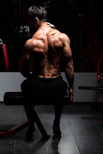 Physically Mature Man Showing His Well Trained Back - 写真・画像