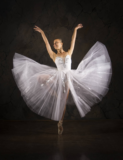 Slender girl in a white corset tutu dancing ballet. - Foto, Imagen