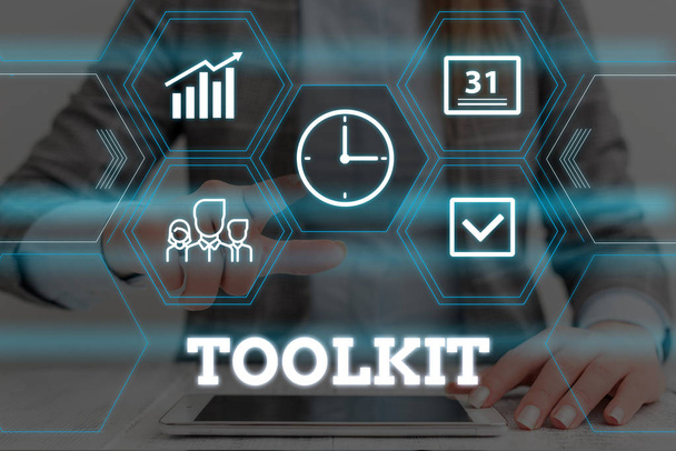 Handwriting text Toolkit. Concept meaning set of tools kept in a bag or box and used for a particular purpose Woman wear formal work suit presenting presentation using smart device. - Photo, Image