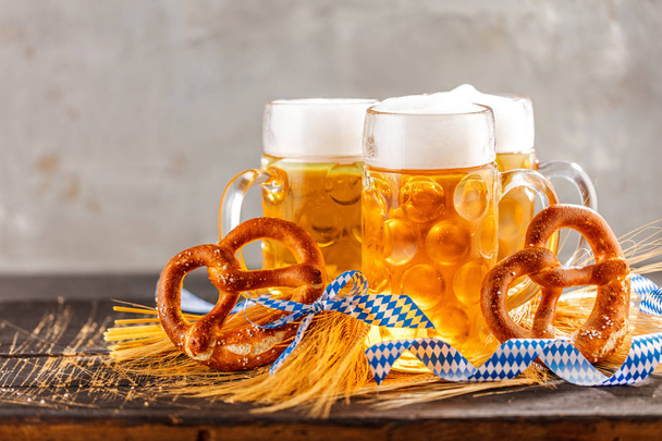 close-up view of fresh cold beer and pretzels on table, oktoberfest concept - Photo, Image