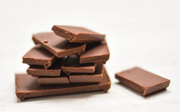 chocolate bar stacked on the white wood background - close up Ch - 写真・画像