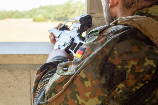 German soldier with a gun at military training area - Photo, Image