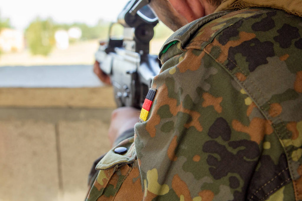 German soldier with a gun at military training area - Foto, Imagen