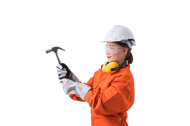 portrait of a woman worker in Mechanic Jumpsuit is holding hamme - Photo, image