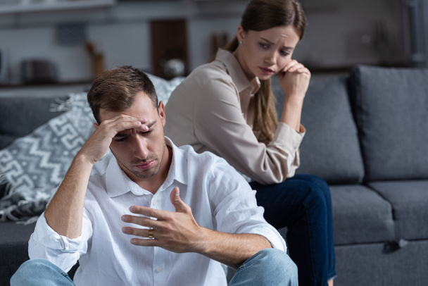 pensive upset couple in living room at home - Photo, Image