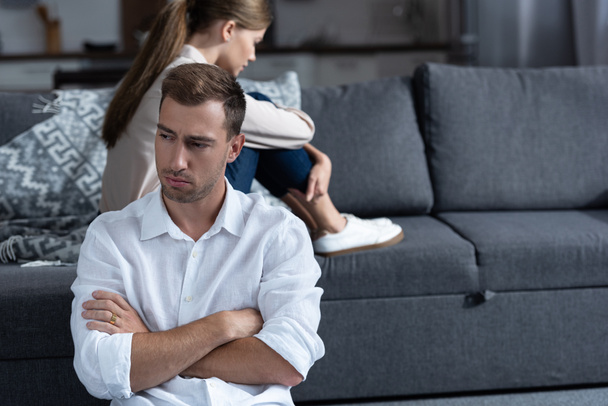 pensive upset couple in living room at home - Photo, Image