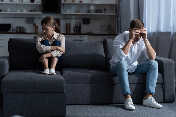 pensive upset couple in living room at home - Фото, изображение