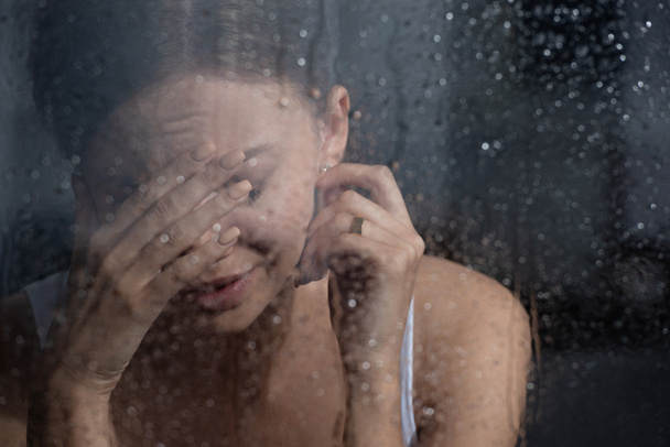selective focus of upset young woman crying at home - Φωτογραφία, εικόνα