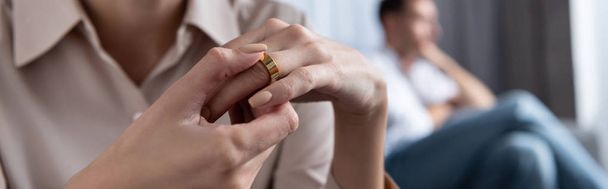 panoramic shot of woman in shirt taking off ring at home - Foto, afbeelding
