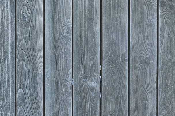 Uma cerca de placas cinzentas lisas. Fundo com textura de madeira velha
. - Foto, Imagem