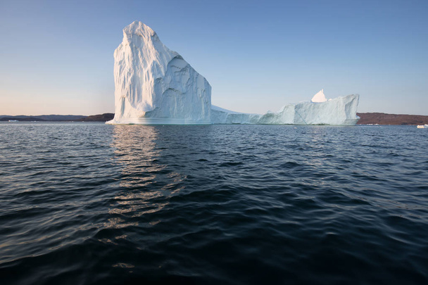 西グリーンランドのディスコ湾には、さまざまな形の巨大な氷山があります。彼らの情報源はヤコブスハーン氷河である。これは地球温暖化と氷の壊滅的な融解の現象の結果です  - 写真・画像