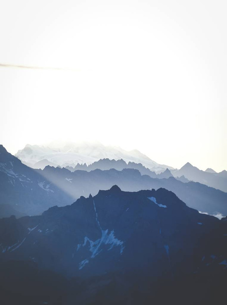 Vertical shot of mountains under a bright sky - Фото, зображення
