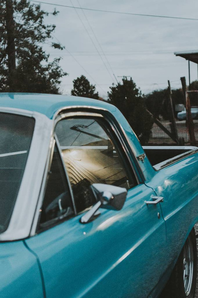 Closeup vertical shot of an old light blue pickup car's left door - Фото, зображення