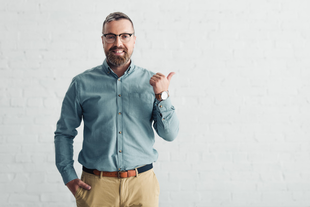 handsome businessman in shirt showing thumb up and looking at camera  - Photo, Image