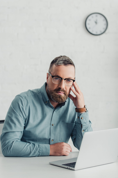 handsome businessman in shirt and glasses looking at camera  - Фото, изображение
