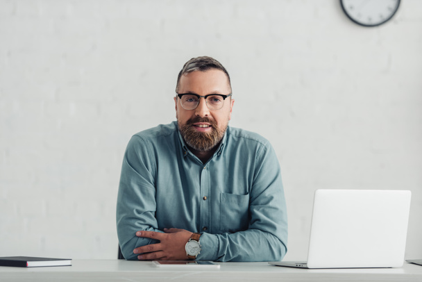 handsome businessman in shirt and glasses looking at camera in office  - Photo, Image
