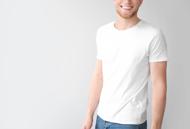 Man in stylish t-shirt on light background - Fotografie, Obrázek