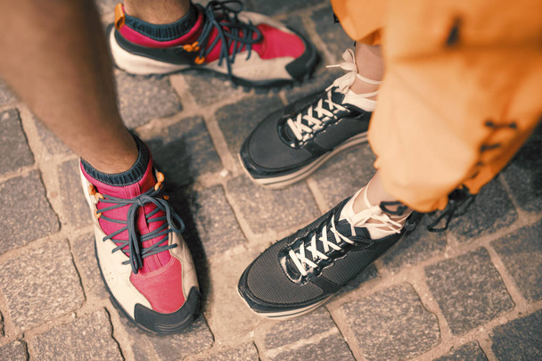 Couple legs in footwear on pavement - Photo, image