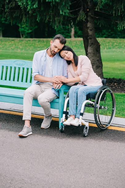 mooie gehandicapte vrouw met knappe vriendje rusten in Park samen - Foto, afbeelding