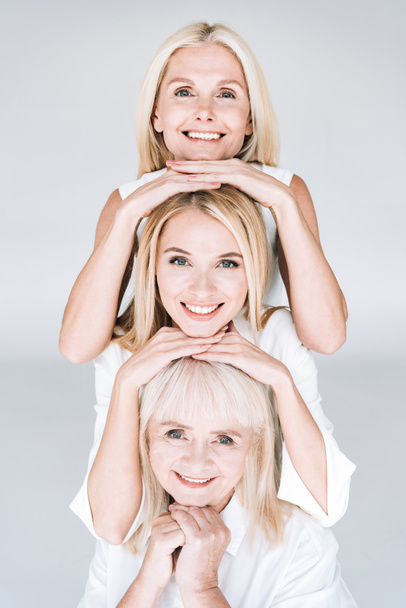 gri izole güzel gülümseyen üç nesil sarışın kadın - Fotoğraf, Görsel