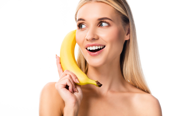 beautiful smiling naked woman with banana near face isolated on white - Photo, Image