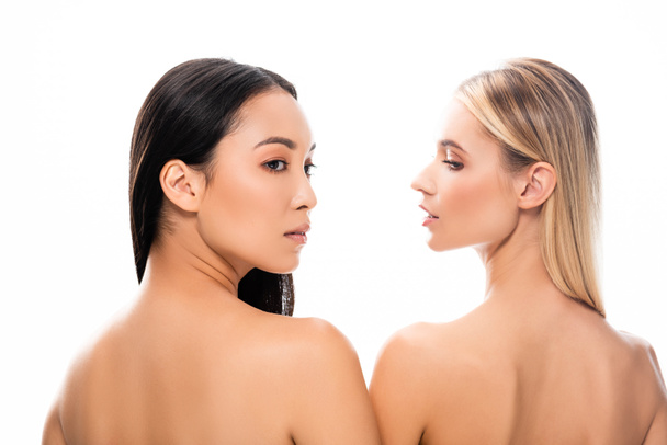 back view of european blonde and asian brunette naked women isolated on white - 写真・画像