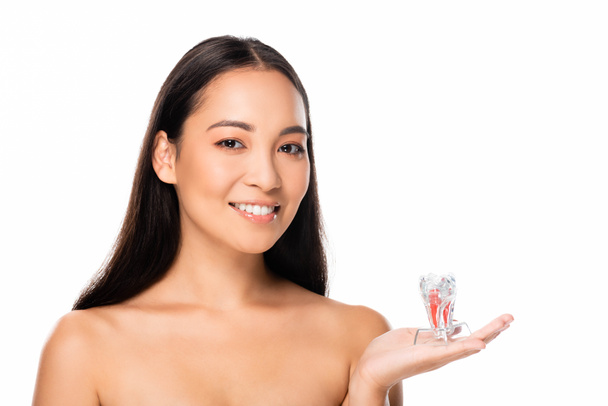 happy naked asian woman holding tooth model isolated on white with copy space - Fotografie, Obrázek