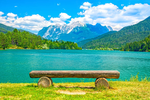 Empty bench on mountain lake shore - Fotó, kép
