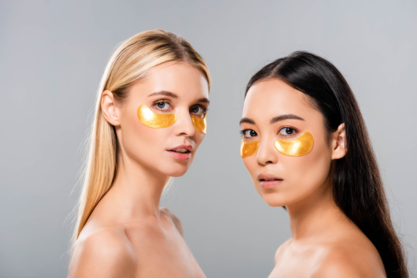 krásné asijské a Evropské nahé dívky s oční skvrnami izolované na šedé - Fotografie, Obrázek