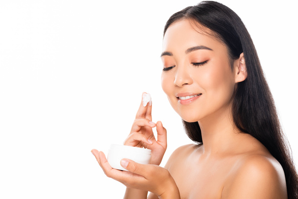 naked beautiful asian woman applying cosmetic cream isolated on white - Photo, Image