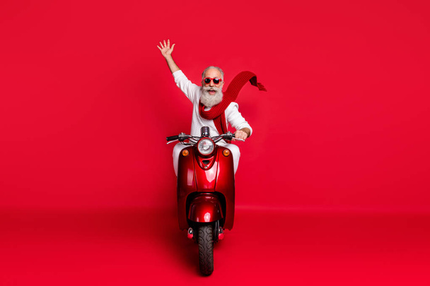 Full size photo of funny pensioner with gray hair driving bike wearing eyewear eyeglasses white pullover isolated over red background - Foto, imagen