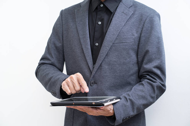 Unrecognize businessman using tablet computer on white backgroun - Foto, immagini