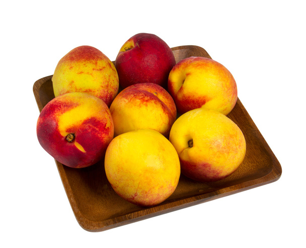 Nectarines in wooden plate - Photo, Image