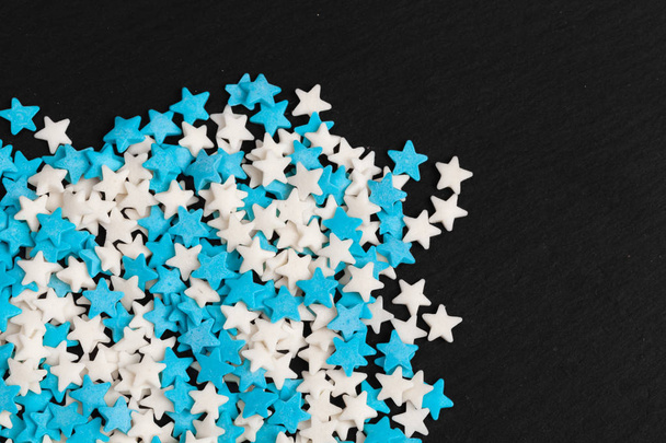 Colored star shaped candy sugar sprinkles as a background - Foto, Bild