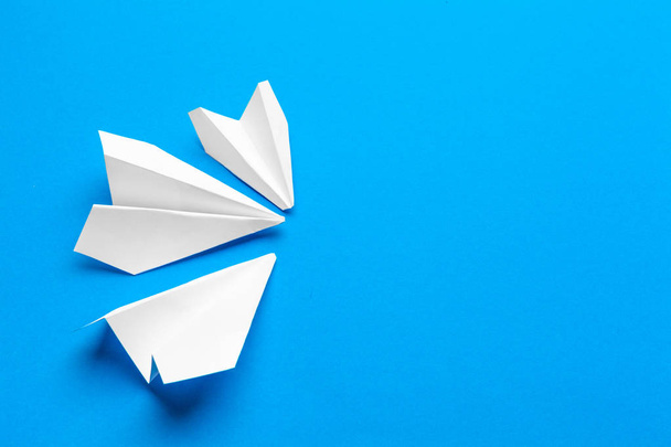 white paper airplane on a navy paper background - Φωτογραφία, εικόνα