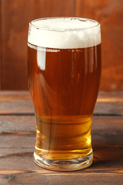 Glass beer on wood background - Фото, изображение