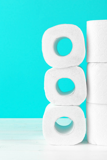 Toilet paper rolls on turquoise bright background - Foto, imagen