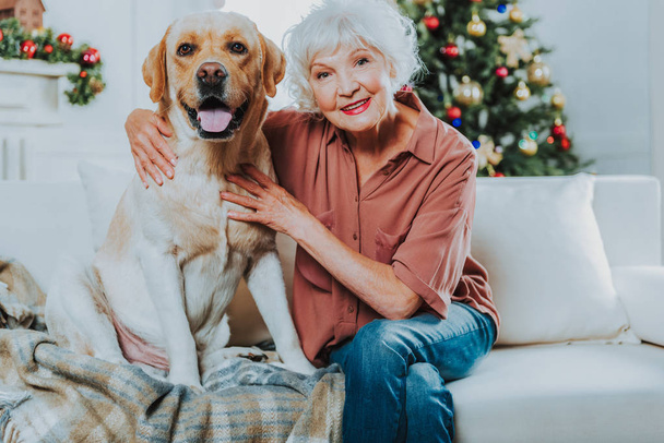 Smiling elegant old lady with her pet - Фото, изображение