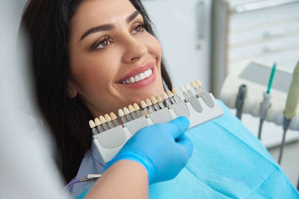 Teeth model locating near smiling woman face - Foto, Imagem