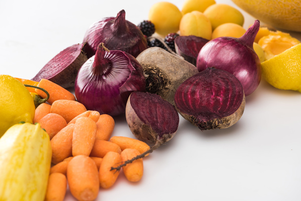 carrots, red onions, beetroots, apricots on white background - Foto, Bild
