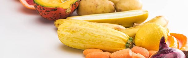 panoramic shot of carrots, zucchini, lemon and potatoes on white background - Photo, image
